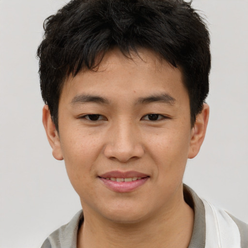 Joyful asian young-adult male with short  brown hair and brown eyes