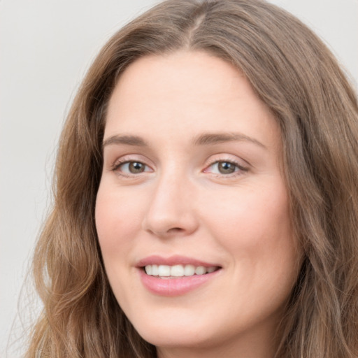 Joyful white young-adult female with long  brown hair and grey eyes