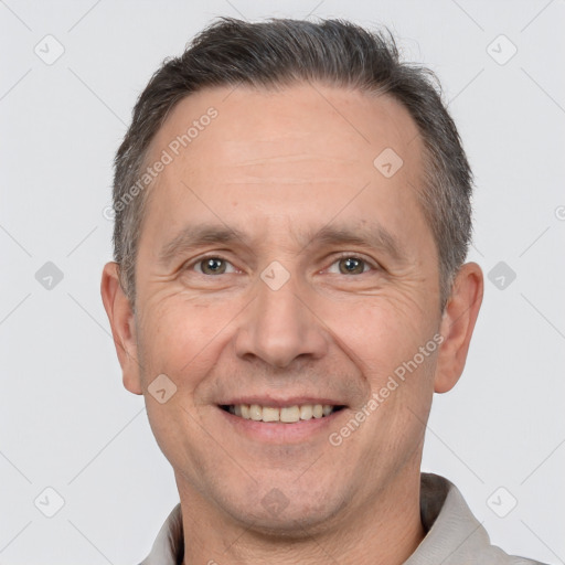 Joyful white adult male with short  brown hair and brown eyes