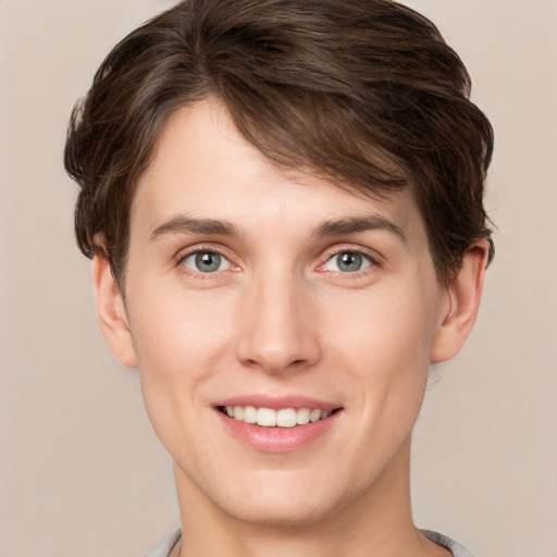 Joyful white young-adult female with short  brown hair and grey eyes