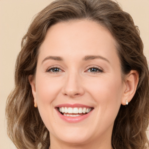 Joyful white young-adult female with long  brown hair and green eyes