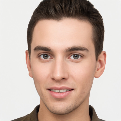 Joyful white young-adult male with short  brown hair and brown eyes