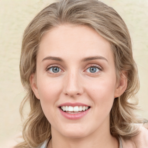 Joyful white young-adult female with medium  brown hair and green eyes