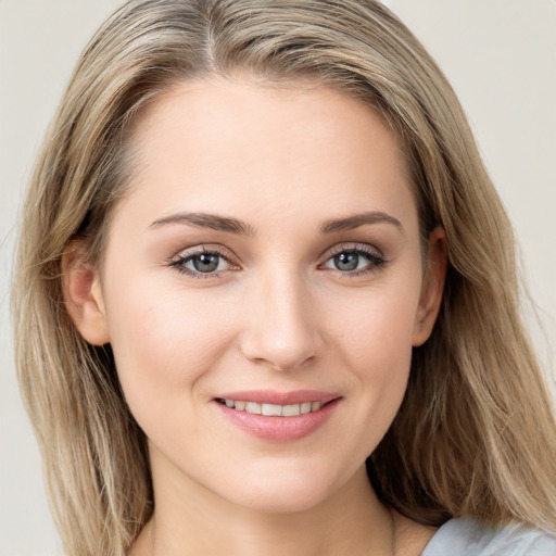 Joyful white young-adult female with long  brown hair and blue eyes