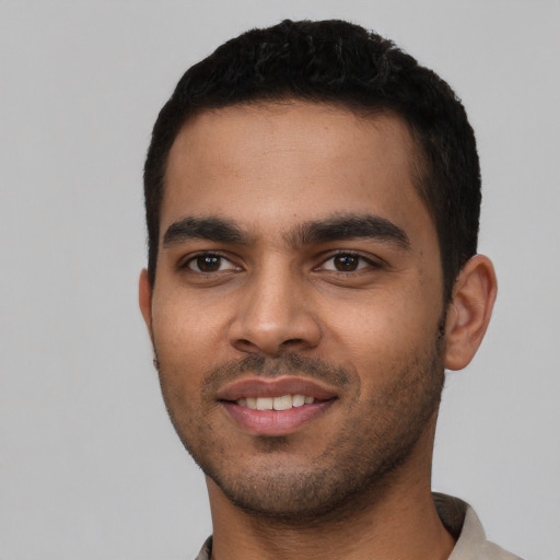 Joyful latino young-adult male with short  black hair and brown eyes