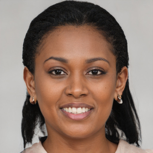 Joyful black young-adult female with medium  brown hair and brown eyes