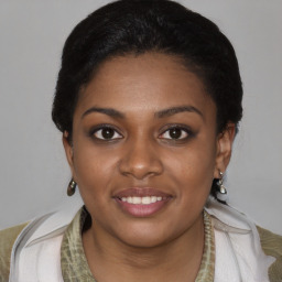 Joyful black young-adult female with short  black hair and brown eyes