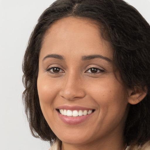 Joyful white young-adult female with long  brown hair and brown eyes