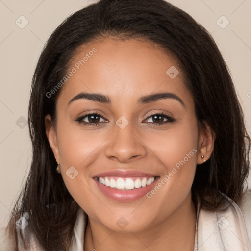 Joyful latino young-adult female with long  brown hair and brown eyes