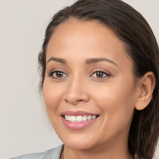 Joyful white young-adult female with long  brown hair and brown eyes