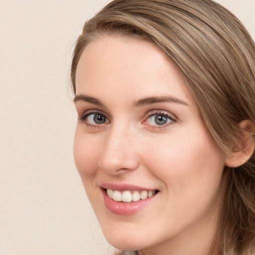 Joyful white young-adult female with long  brown hair and green eyes