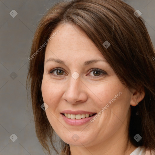 Joyful white adult female with medium  brown hair and brown eyes