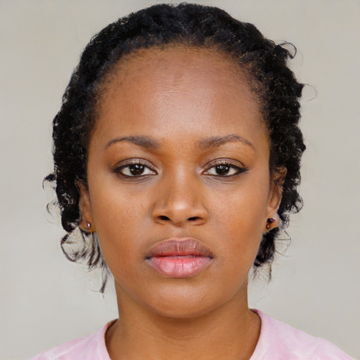 Neutral black young-adult female with medium  brown hair and brown eyes