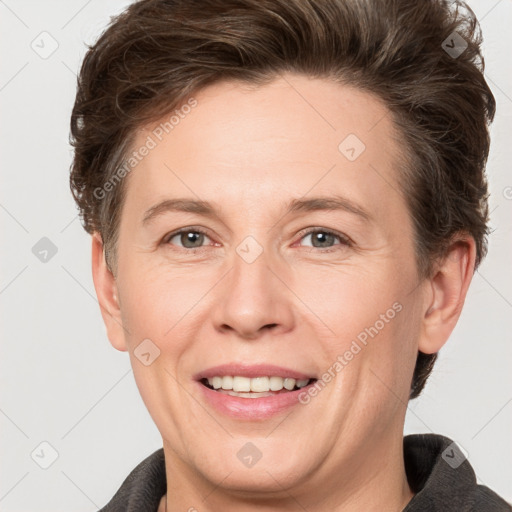 Joyful white adult female with short  brown hair and grey eyes