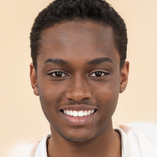 Joyful black young-adult male with short  brown hair and brown eyes