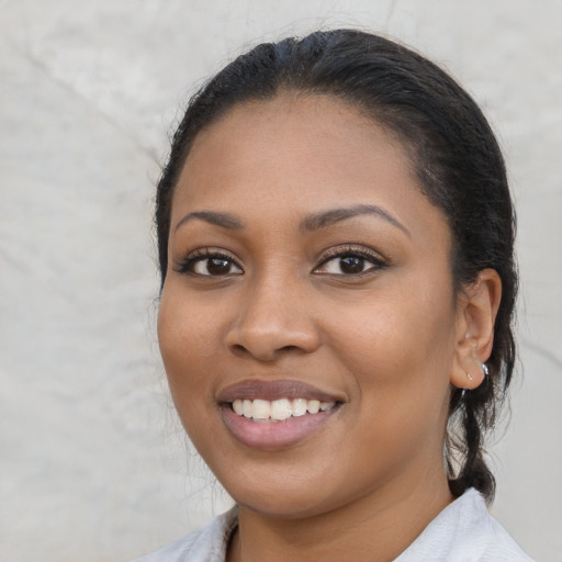 Joyful latino young-adult female with medium  brown hair and brown eyes