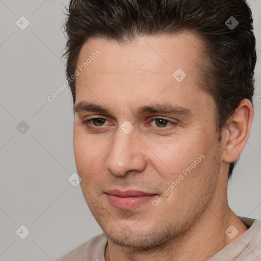 Joyful white adult male with short  brown hair and brown eyes