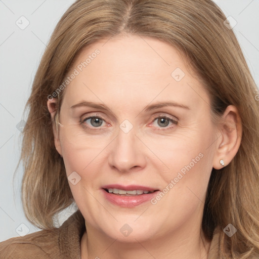 Joyful white adult female with long  brown hair and brown eyes