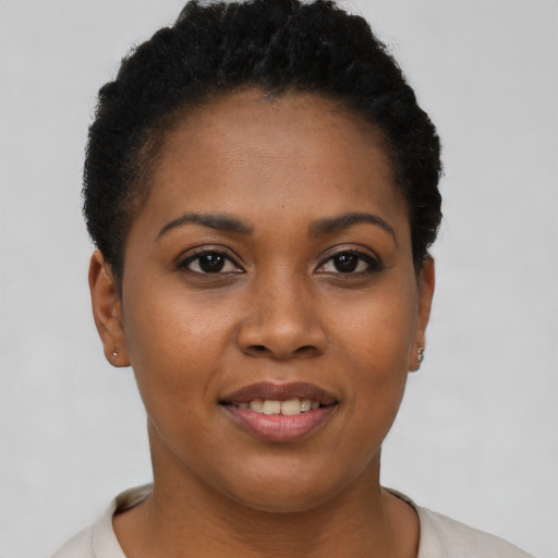 Joyful black young-adult female with short  brown hair and brown eyes