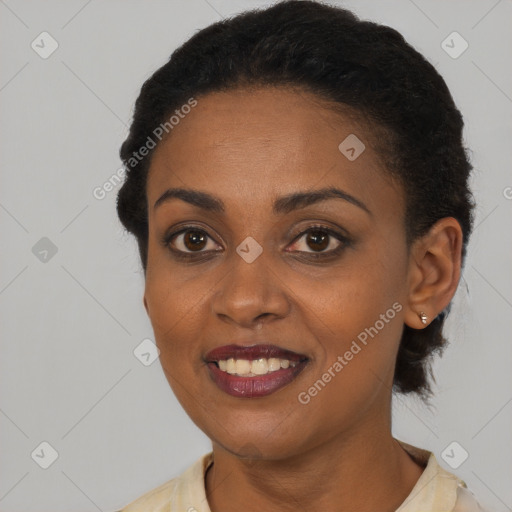 Joyful black young-adult female with short  black hair and brown eyes