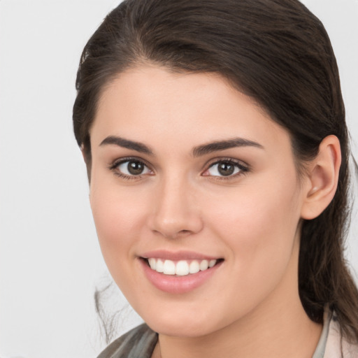 Joyful white young-adult female with medium  brown hair and brown eyes