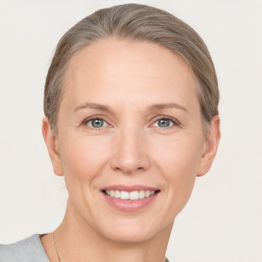 Joyful white adult female with short  brown hair and grey eyes