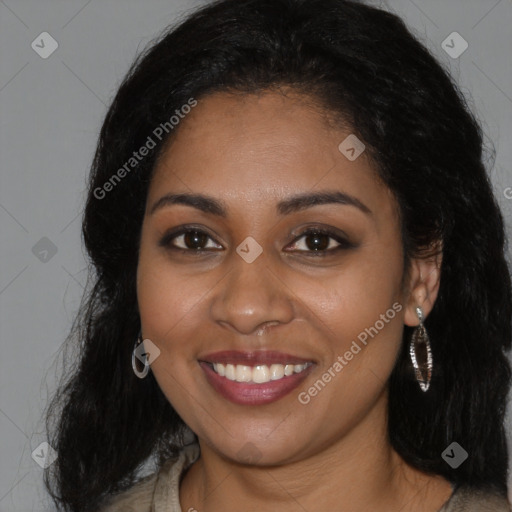 Joyful black young-adult female with long  brown hair and brown eyes