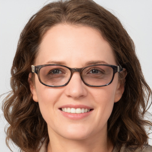 Joyful white young-adult female with long  brown hair and green eyes