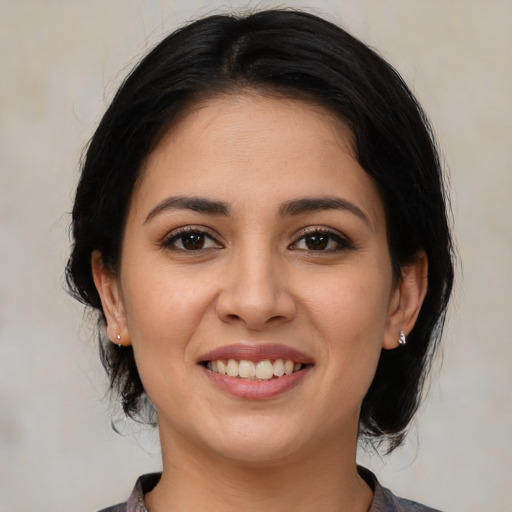 Joyful white young-adult female with medium  brown hair and brown eyes