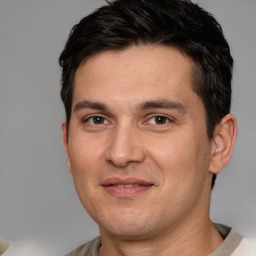 Joyful white adult male with short  brown hair and brown eyes