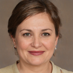 Joyful white adult female with medium  brown hair and brown eyes