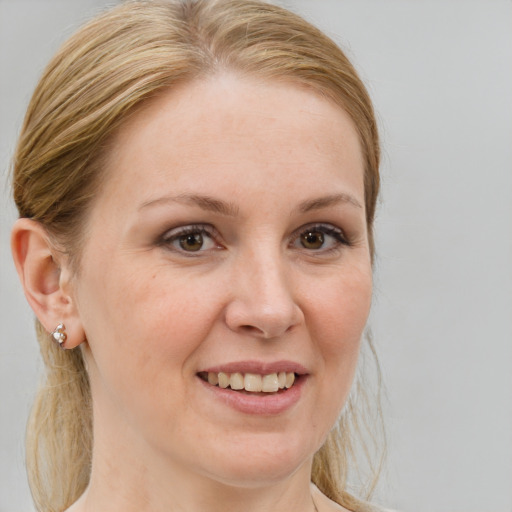 Joyful white young-adult female with medium  brown hair and brown eyes