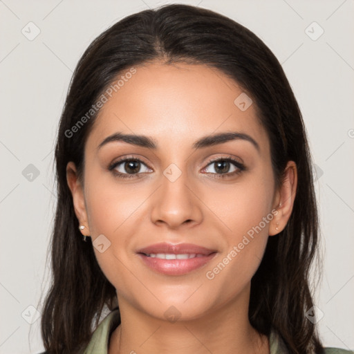 Joyful latino young-adult female with long  brown hair and brown eyes