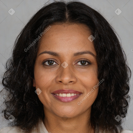 Joyful black young-adult female with long  brown hair and brown eyes