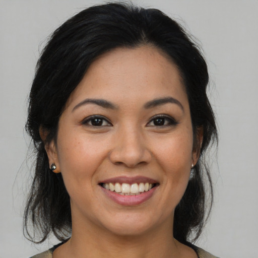 Joyful asian young-adult female with medium  brown hair and brown eyes