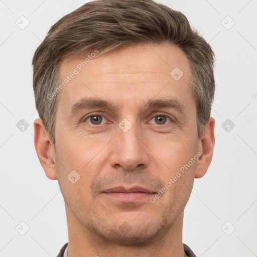 Joyful white adult male with short  brown hair and grey eyes