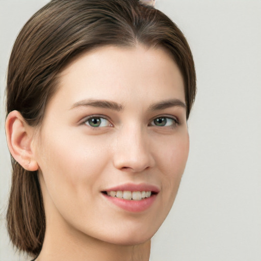 Joyful white young-adult female with long  brown hair and green eyes