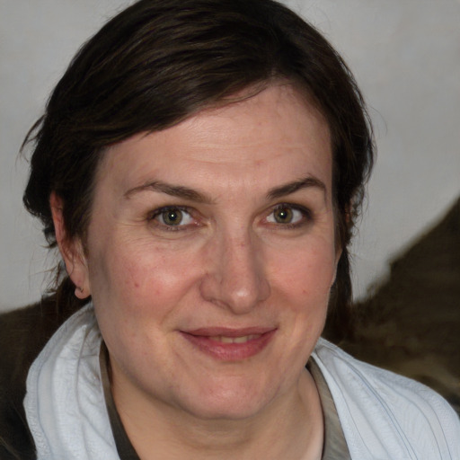 Joyful white adult female with medium  brown hair and blue eyes