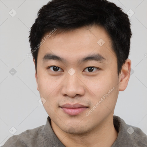 Joyful asian young-adult male with short  black hair and brown eyes