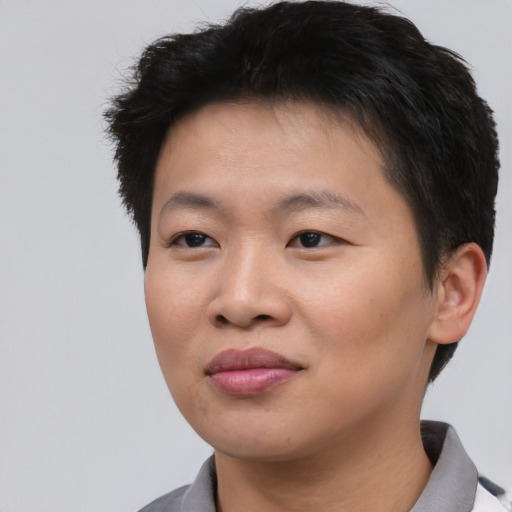 Joyful asian young-adult female with short  black hair and brown eyes