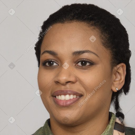 Joyful black young-adult female with short  black hair and brown eyes