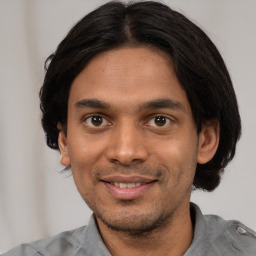 Joyful white young-adult male with short  black hair and brown eyes