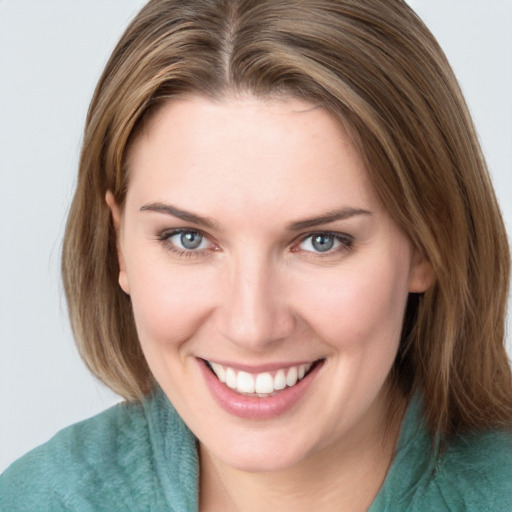 Joyful white young-adult female with medium  brown hair and green eyes