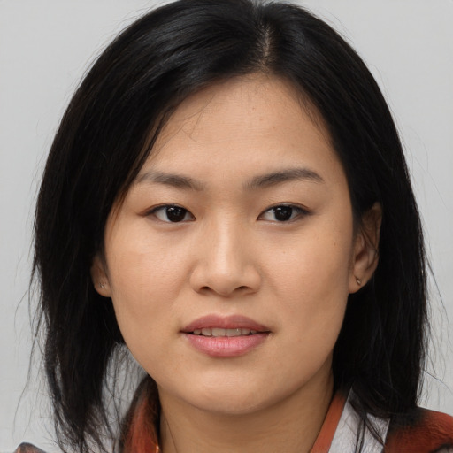 Joyful asian young-adult female with medium  black hair and brown eyes