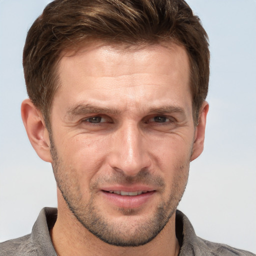 Joyful white adult male with short  brown hair and grey eyes