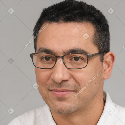 Joyful white adult male with short  black hair and brown eyes