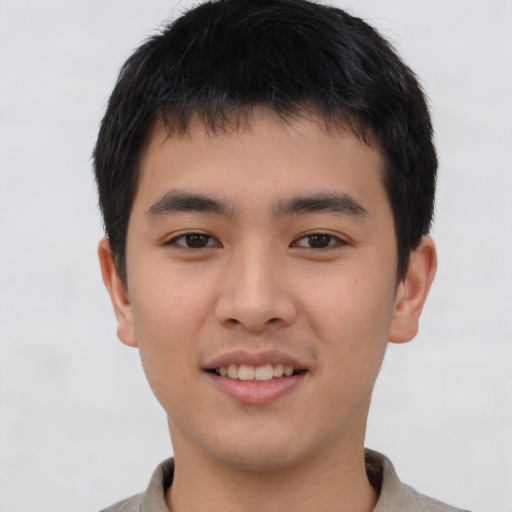 Joyful asian young-adult male with short  brown hair and brown eyes