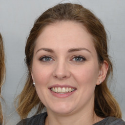 Joyful white young-adult female with medium  brown hair and blue eyes