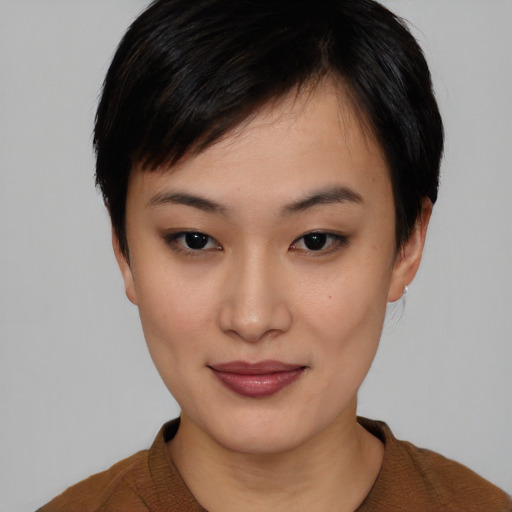 Joyful asian young-adult female with short  black hair and brown eyes