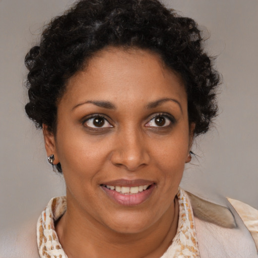 Joyful black young-adult female with medium  brown hair and brown eyes